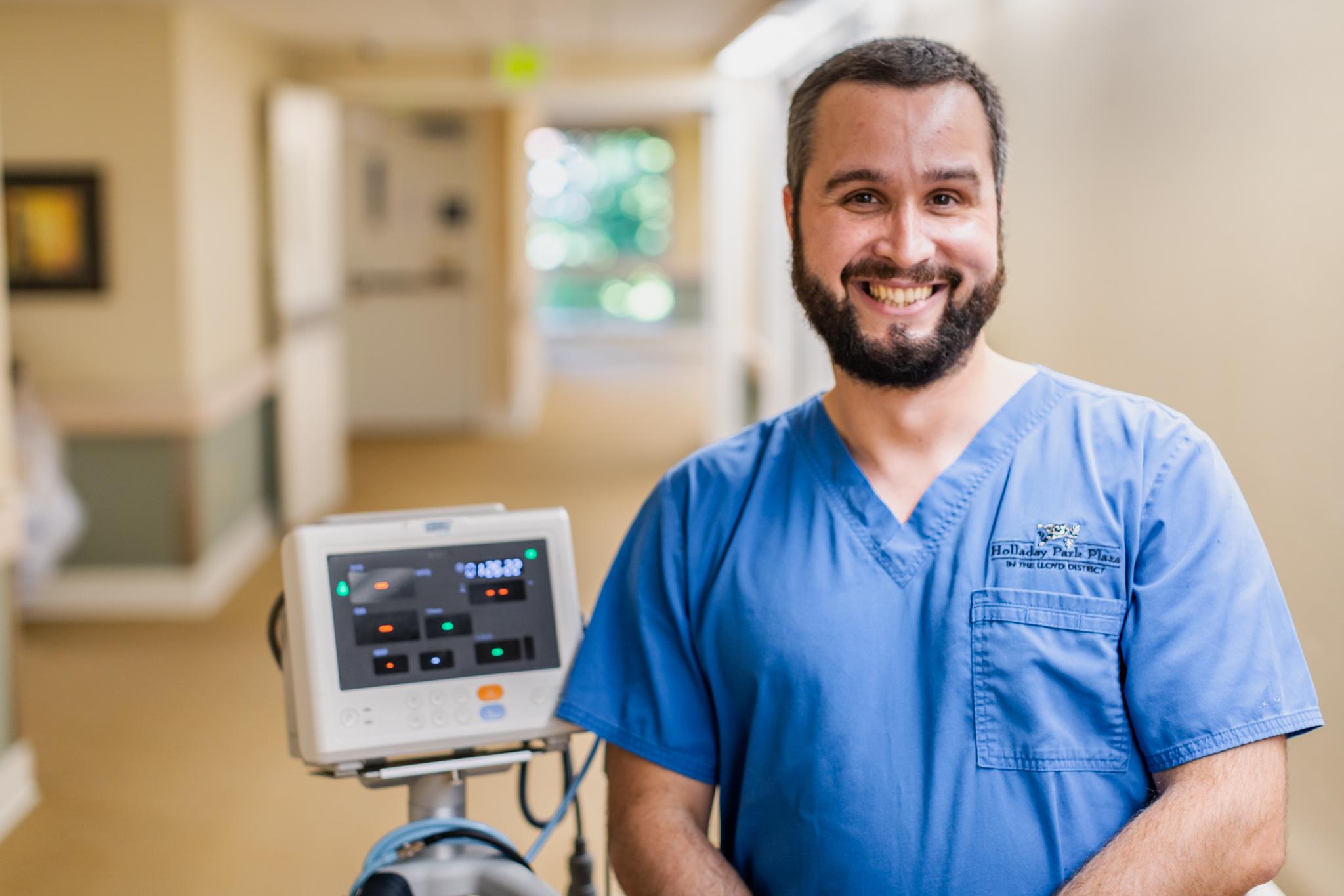 A nursing employee is pictured with a piece of equipment.